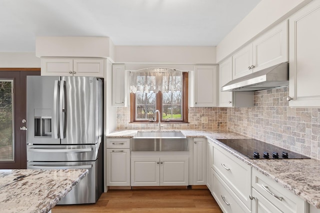 4675 Treat Hwy, Adrian, MI 49221 - kitchen featuring white cabinets, stainless steel fridge, a sink, under cabinet range hood, and black electric stovetop