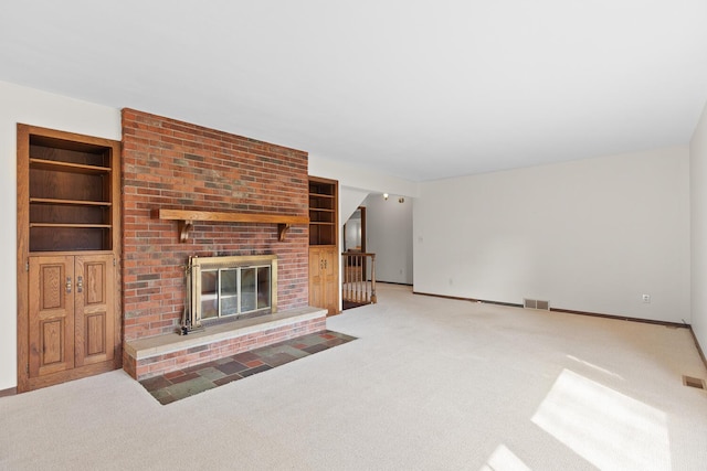 4675 Treat Hwy, Adrian, MI 49221 - living area featuring built in features, a fireplace, visible vents, carpet floors, and baseboards