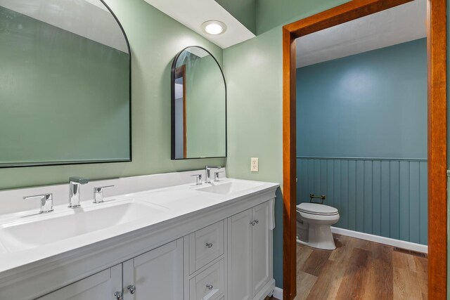 4675 Treat Hwy, Adrian, MI 49221 - bathroom with wainscoting, a sink, toilet, and wood finished floors