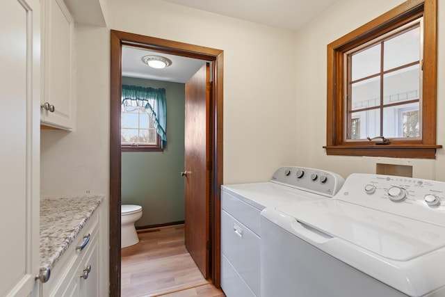 4675 Treat Hwy, Adrian, MI 49221 - laundry area featuring cabinet space, washing machine and clothes dryer, and light wood-type flooring