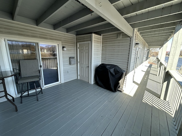 wooden terrace with a grill