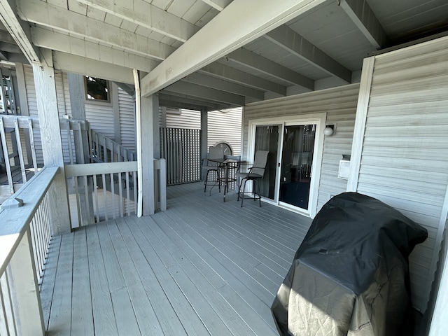 wooden terrace featuring a grill