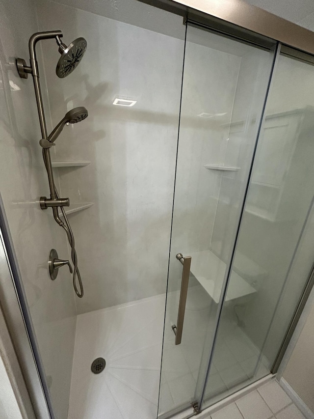 full bathroom featuring a stall shower and tile patterned floors