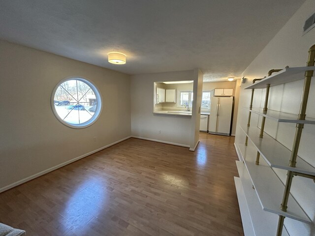 interior space featuring baseboards and wood finished floors