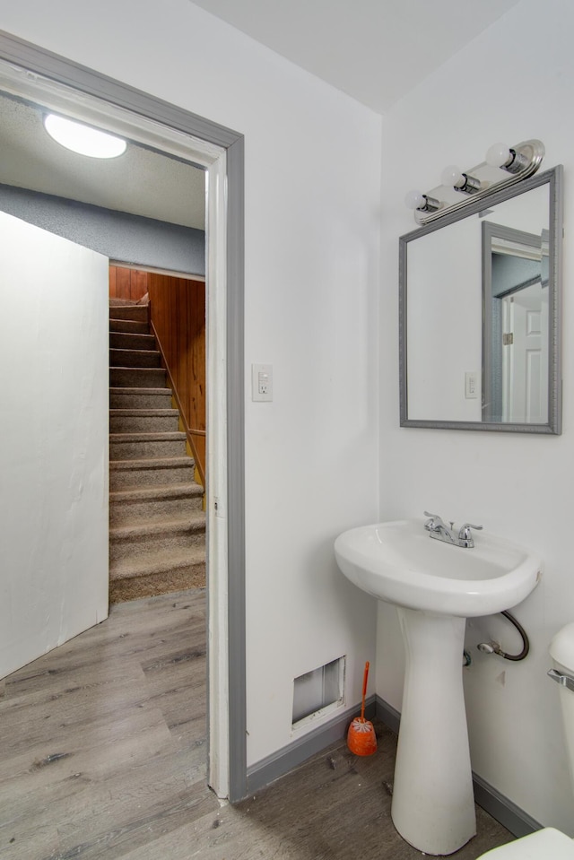 bathroom with baseboards and wood finished floors