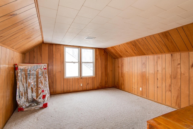 bonus room featuring wood walls, carpet floors, and lofted ceiling
