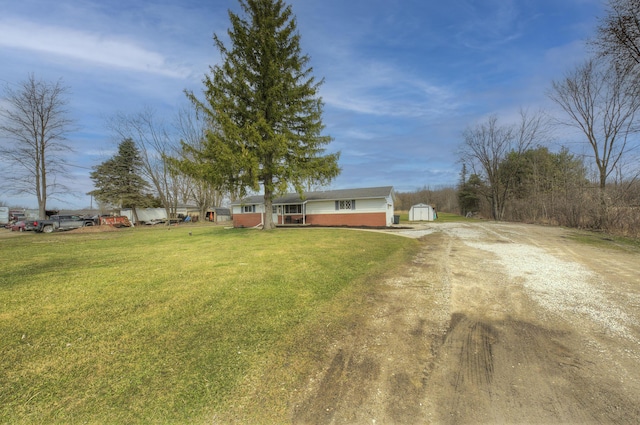 8550 Gratiot Ave, Columbus, MI 48063 - view of yard with an outdoor structure, driveway, and a storage shed