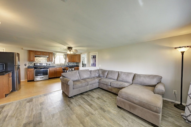 8550 Gratiot Ave, Columbus, MI 48063 - living room with baseboards, light wood-type flooring, and a ceiling fan