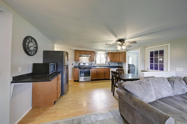 8550 Gratiot Ave, Columbus, MI 48063 - living room featuring light wood-type flooring, baseboards, and a ceiling fan