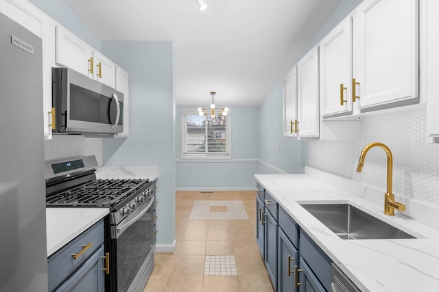 2817 Cumberland Ave, Ann Arbor, MI 48104 - kitchen with stainless steel appliances, a notable chandelier, white cabinets, and a sink