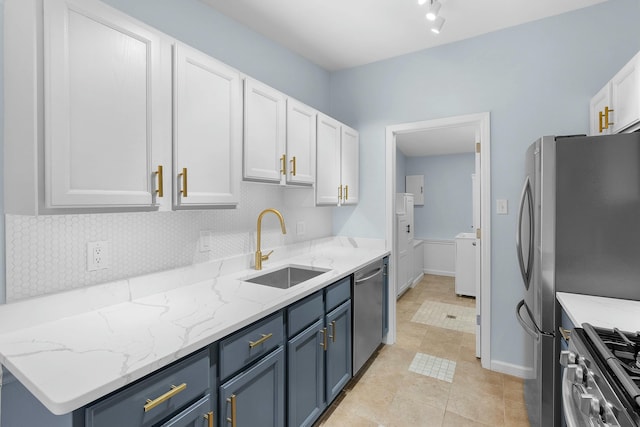 2817 Cumberland Ave, Ann Arbor, MI 48104 - kitchen with appliances with stainless steel finishes, a sink, white cabinetry, decorative backsplash, and blue cabinets