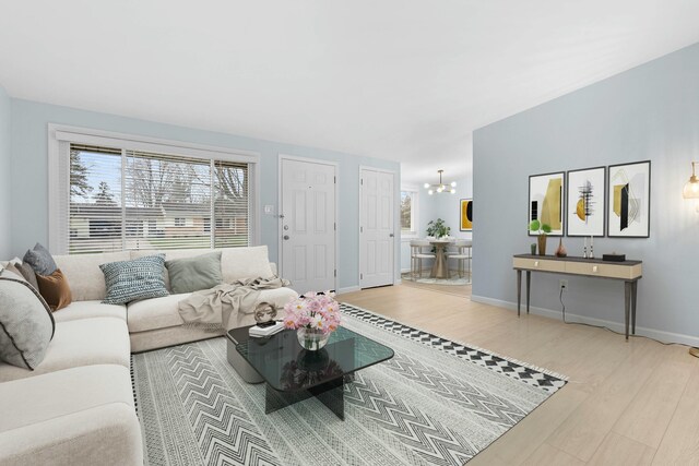 2817 Cumberland Ave, Ann Arbor, MI 48104 - living area with wood finished floors, an inviting chandelier, and baseboards