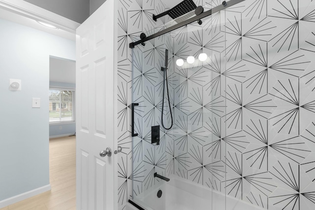 2817 Cumberland Ave, Ann Arbor, MI 48104 - bathroom with wood finished floors, baseboards, and  shower combination