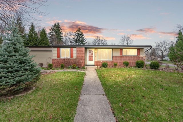 2817 Cumberland Ave, Ann Arbor, MI 48104 - ranch-style home with brick siding, a front lawn, and a garage