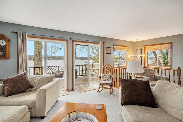 15095 N Barton Lake Dr, Vicksburg, MI 49097 - living area featuring a water view, a chandelier, and light carpet