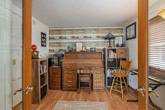 15095 N Barton Lake Dr, Vicksburg, MI 49097 - office area featuring wood finished floors and an accent wall