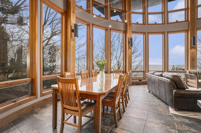 6993 S Lakeshore Dr, Pentwater, MI 49449 - sunroom / solarium featuring a water view and stone tile floors