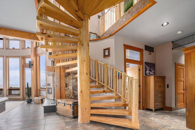 6993 S Lakeshore Dr, Pentwater, MI 49449 - stairway featuring visible vents, a high ceiling, and recessed lighting