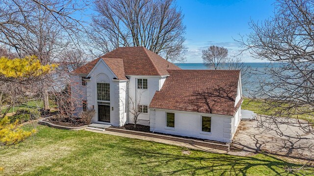 6376 Sterling Dr, Newport, MI 48166 - exterior space with a yard, a shingled roof, a water view, and stucco siding