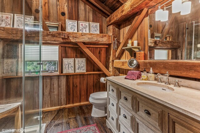 12801 Hills Rd, Buchanan, MI 49107 - full bath featuring vaulted ceiling, wood walls, wood finished floors, vanity, and toilet