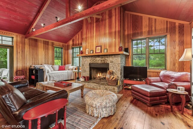 12801 Hills Rd, Buchanan, MI 49107 - living room featuring vaulted ceiling with beams, wooden walls, a wealth of natural light, and hardwood / wood-style floors