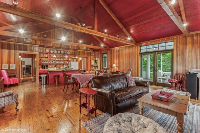 12801 Hills Rd, Buchanan, MI 49107 - living area featuring visible vents, wood walls, lofted ceiling with beams, and hardwood / wood-style floors