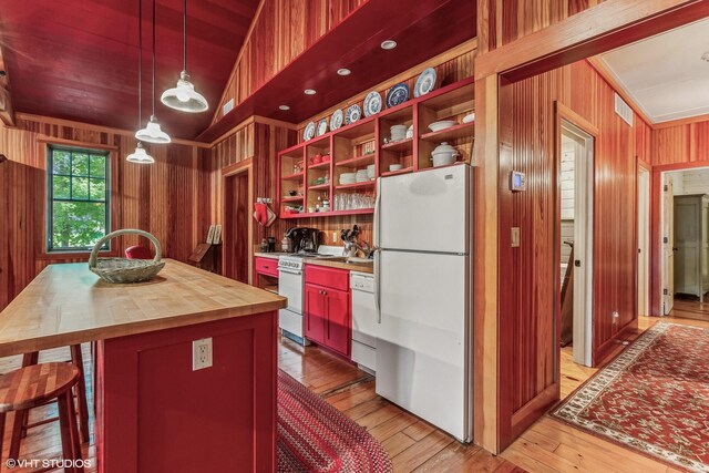 12801 Hills Rd, Buchanan, MI 49107 - kitchen featuring visible vents, light wood-type flooring, wooden walls, wood counters, and white appliances