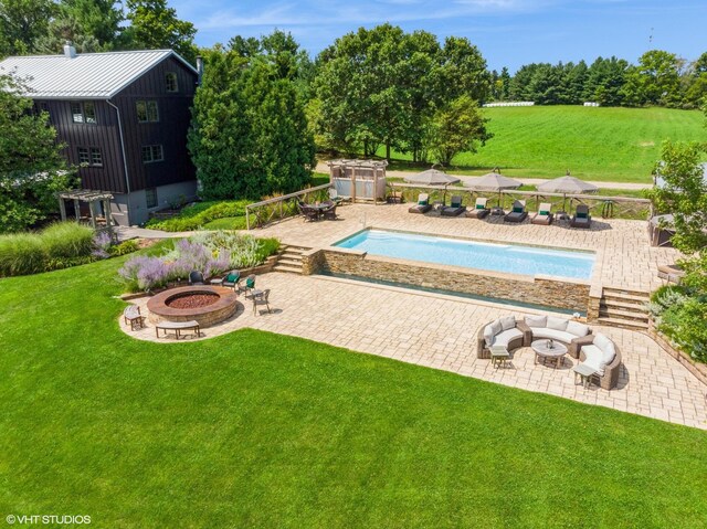 12801 Hills Rd, Buchanan, MI 49107 - pool with a lawn, a patio area, and an outdoor living space with a fire pit