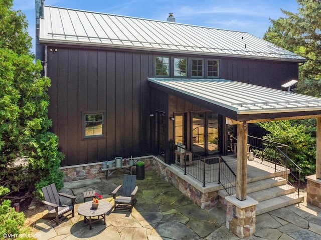 12801 Hills Rd, Buchanan, MI 49107 - rear view of house with metal roof, a chimney, and a standing seam roof
