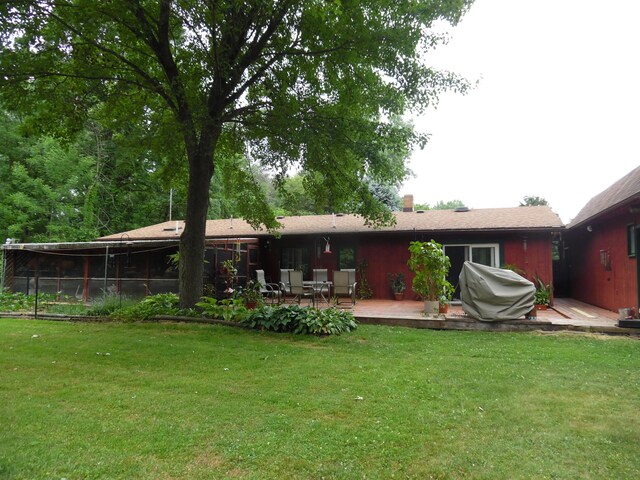 7190 Thornapple River Ct SE, Alto, MI 49302 - rear view of house with a wooden deck and a lawn