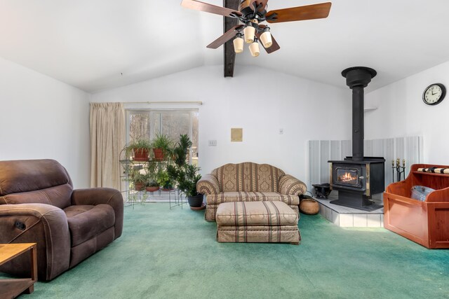 7190 Thornapple River Ct SE, Alto, MI 49302 - living room with vaulted ceiling with beams, a wood stove, a ceiling fan, and carpet flooring