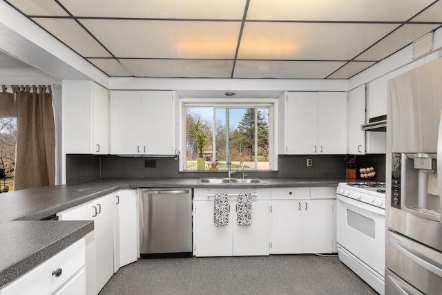 7190 Thornapple River Ct SE, Alto, MI 49302 - kitchen featuring a sink, decorative backsplash, appliances with stainless steel finishes, and dark countertops