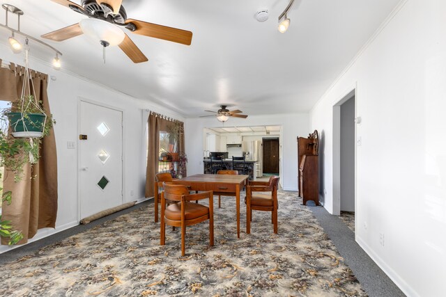 7190 Thornapple River Ct SE, Alto, MI 49302 - dining room featuring ornamental molding, baseboards, a ceiling fan, and carpet