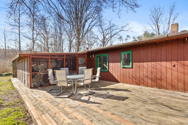 7190 Thornapple River Ct SE, Alto, MI 49302 - wooden deck with a sunroom and outdoor dining area