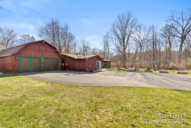 7190 Thornapple River Ct SE, Alto, MI 49302 - view of home's exterior with a barn, a yard, driveway, and an outbuilding