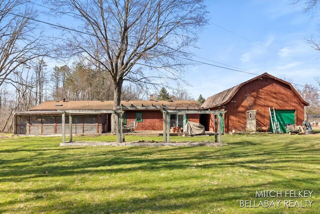 7190 Thornapple River Ct SE, Alto, MI 49302 - rear view of house featuring a barn, a gambrel roof, an outdoor structure, and a lawn