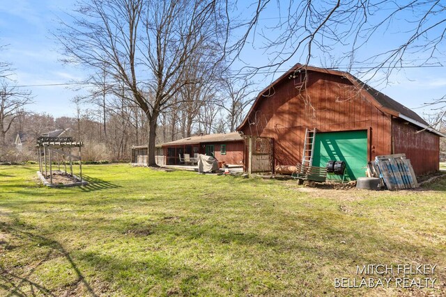 7190 Thornapple River Ct SE, Alto, MI 49302 - exterior space with a barn, an outbuilding, a garage, and a lawn