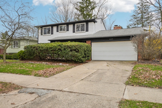 2380 Nixon Rd, Ann Arbor, MI 48105 - traditional-style home with a chimney, driveway, a garage, and brick siding