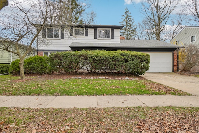 2380 Nixon Rd, Ann Arbor, MI 48105 - view of front facade featuring brick siding, an attached garage, and concrete driveway