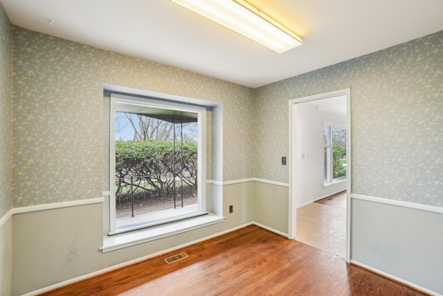 2380 Nixon Rd, Ann Arbor, MI 48105 - unfurnished room featuring visible vents, wood finished floors, and wallpapered walls