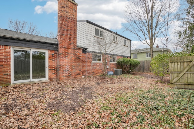 2380 Nixon Rd, Ann Arbor, MI 48105 - rear view of house with brick siding, fence, and a chimney