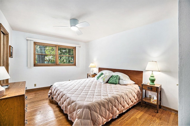 575 Glenwood Ave, Muskegon, MI 49445 - bedroom with hardwood / wood-style flooring, baseboards, and ceiling fan