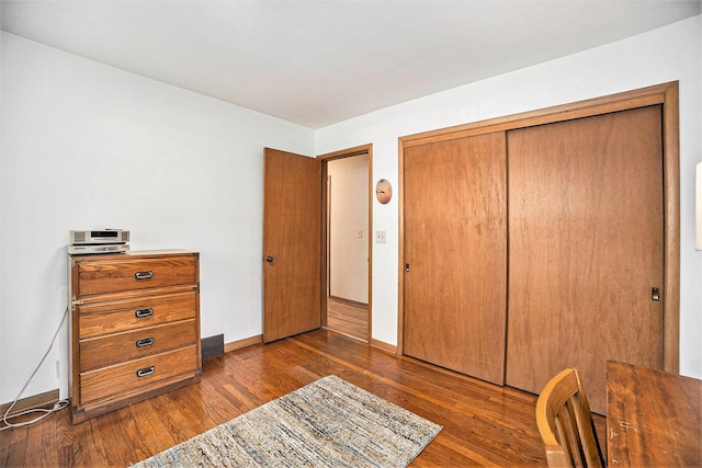575 Glenwood Ave, Muskegon, MI 49445 - bedroom with dark wood-type flooring, baseboards, and a closet