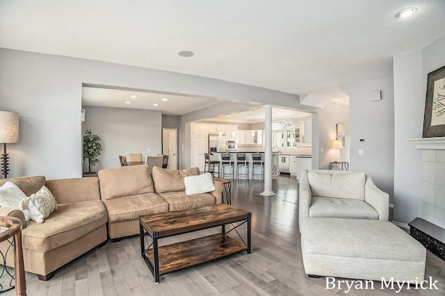 921 Meadow Ridge Dr, Holland, MI 49424 - living room featuring light wood-type flooring, ornate columns, and recessed lighting