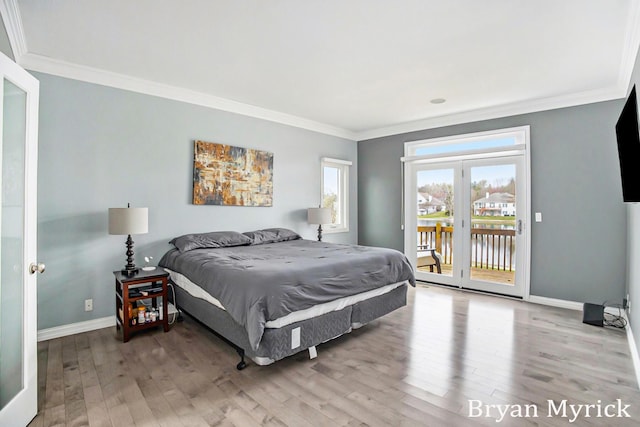 921 Meadow Ridge Dr, Holland, MI 49424 - bedroom with baseboards, access to exterior, ornamental molding, and wood finished floors