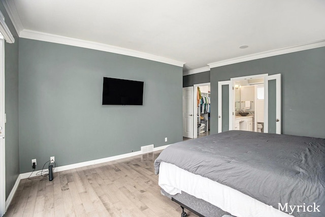 921 Meadow Ridge Dr, Holland, MI 49424 - bedroom with a closet, ornamental molding, a spacious closet, wood finished floors, and baseboards