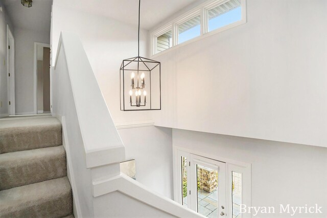 921 Meadow Ridge Dr, Holland, MI 49424 - stairway featuring a chandelier