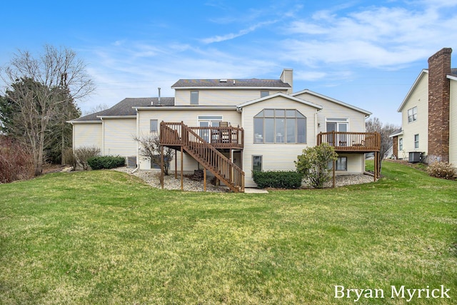 921 Meadow Ridge Dr, Holland, MI 49424 - rear view of house with stairs, central AC unit, a wooden deck, and a lawn