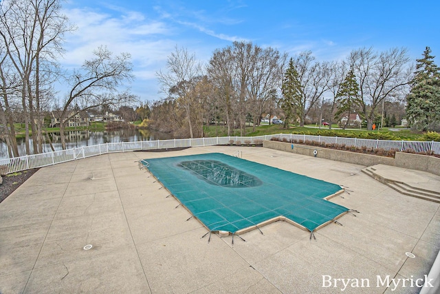921 Meadow Ridge Dr, Holland, MI 49424 - pool with a water view, a patio area, and fence