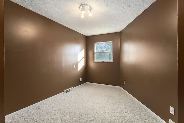 620 Twin Lakes Dr NE, Grand Rapids, MI 49525 - spare room featuring a textured ceiling, carpet flooring, and baseboards